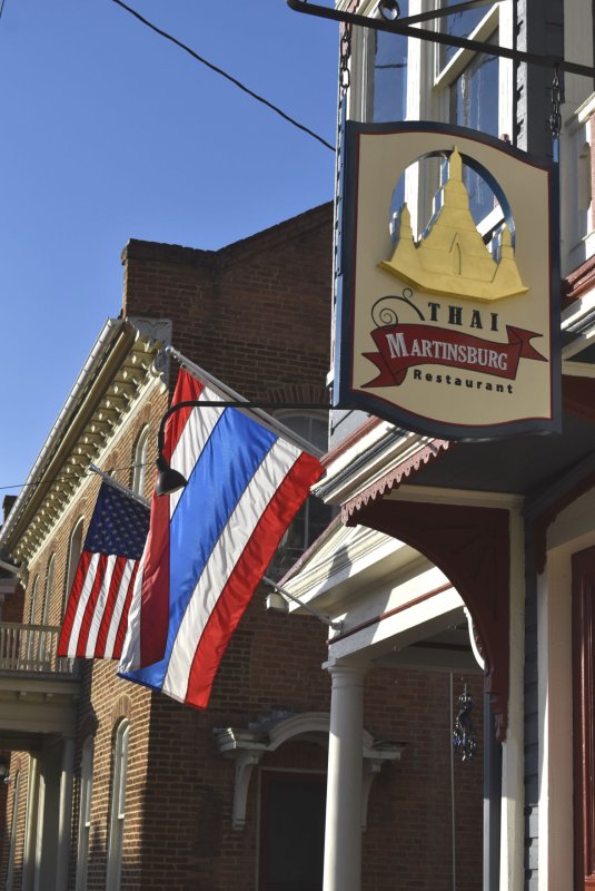 Flag, Architecture, Building, Person. Text: THAI MARTINSBURG Restaurant