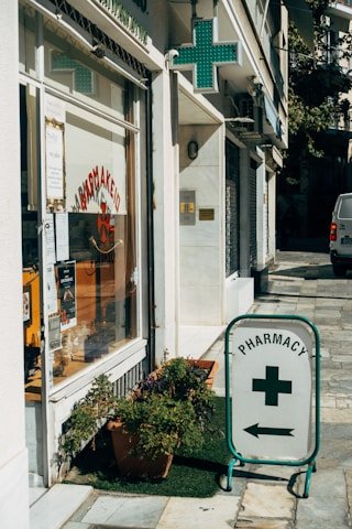 Potted Plant, City, Street, Car. Text: PHARMACY +