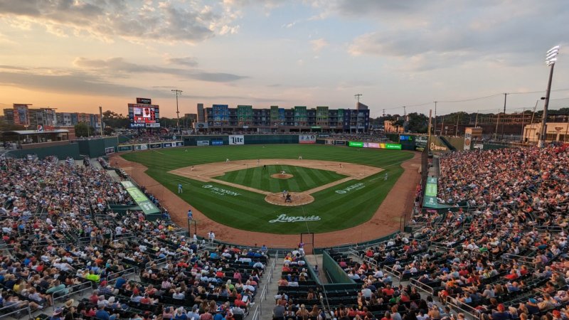 Baseball, Baseball Game, Person, Scoreboard. Text: JACKSON LAFCU Lite BNL Lite 8 Sparrow JACKSON Lugnuts