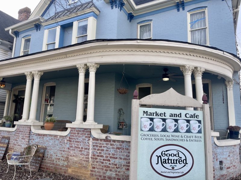 Building, Housing, House, Portico. Text: Market and Cafe GROCERIES, LOCAL WINE &amp; CRAFT BEER COFFEE, SOUPS, SANDWICHES &amp; ENTREES LLC Market and Vegetarian Cafe