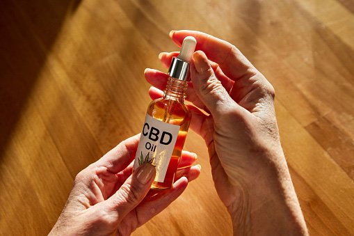 Bottle, Baby, Person, Perfume. Text: CBD Oil