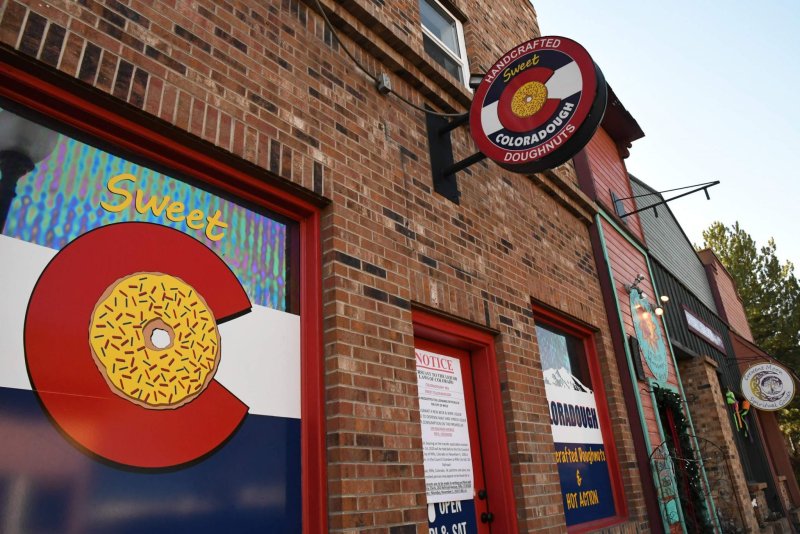 Brick, City, Urban, Building. Text: COLORADOUGH DOUGHNUTS Sweet NOTICE Crescent Moon LORADOUGH crafted Doughnuts HOT ACTION OPEN