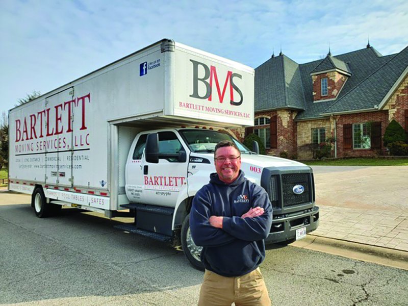 Truck, Adult, Man, Person. Text: BMS BARTLETT MOVING SERVICES LLC BARTLETT MOVING SERVICES, LLC 003 SAFES