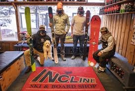 Adult, Male, Man, Person. Text: SKI &amp; BOARD SHOP