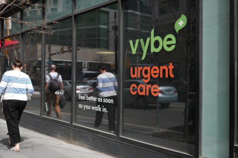 Person, Walking, Backpack, Woman. Text: + vybe urgent tments care Feel better as soon as you walk in.