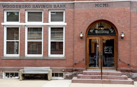 Bench, City, Brick, Building. Text: MCMI. WOODSBORO SAVINGS BANK. WOODSBORO BANK