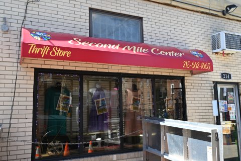 Person, Restaurant, Lamp, Woman. Text: FRIGIDAIRE Second Mile Center Thrift Store 215-662-1663 214 BAGS and