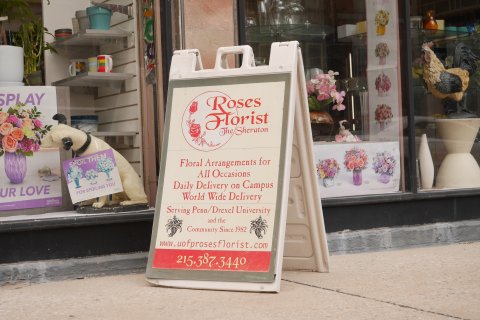 Chicken, Advertisement, Cup, Poster. Text: SPLAY Roses Florist The Sheraton teleflora SPOIL THEM Floral Arrangements for Daily Delivery on Campus UR LOVE FOR SPOILING YOU teleflora World Wide Delivery LOVE OUT LOUD Serving Penn/Drexel University and th...