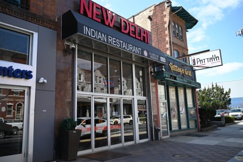 Plant, Path, Car, Restaurant. Text: NEW DELAT INDIAN RESTAURANT CLOSED ON MONDAYS 4004 nters Pattaya Grill Thai Cuisine Out 8533 &amp; Catering EN New Delhi OPEN Wines Beers