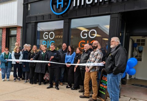 Jeans, Jacket, Man, Person. Text: GO GO BIG GIG SPEED FIBER