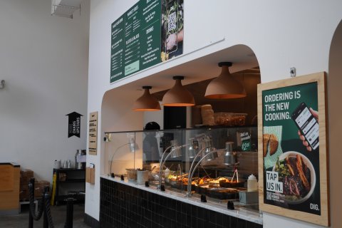 Cafeteria, Restaurant, Mobile Phone, Lamp. Text: MARKET SIDES COLD DIG. MAKE YOUR OWN DRINKS PLATES&amp;SALADS Culture Pop Coke Diet Coke MORE CHAIRS UPSTAIRS RESTROOM ORDERING IS THE NEW COOKING. Add an avocado! EXECUTIVE $2.25 REDEEM YOUR REWARDS RED...