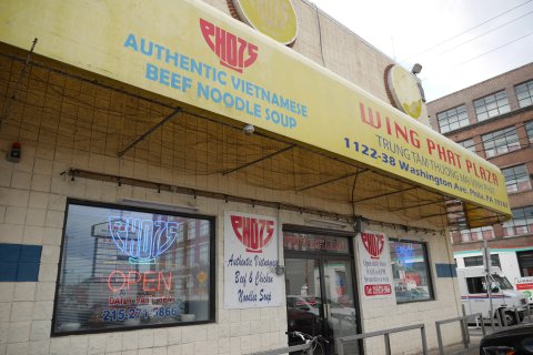 Building, Car, Truck, Restaurant. Text: AUTHENTIC VIETNAMESE BEEF NOODLE SOUP WING PHAT PLAZA 1122-38 Washington Ave. Phila.PA 19147 PHO 75 RESTAURANT Authentic Vietnamese Open daily from: OPEN Beef &amp; Chicken Seven days a week OPEN WiFi UHAU Tel: 2...