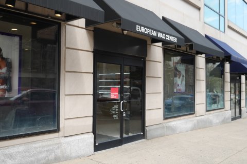 Awning, Canopy, Lamp, Person. Text: EUROPEAN WAX CENTER EUROPEAN WAX CENTER WALK IN STRUT OUT waxcenter.com