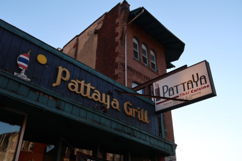 Sign, Symbol, Brick, Factory. Text: Pattaya Grill PATTAYA Thai Cuisine Tak Out &amp; Catering 8533 Dine-In, 215-3