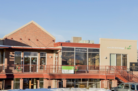 City, Car, Office Building, Urban. Text: vail dermatology I skin vail dermatology skin MILLENNIUM BANK
