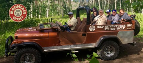 Adult, Female, Person, Woman. Text: MOUNTAIN WOLF JEEP ADVENTURES, INC. MOUNTAIN 970-926-WOLF PUC ORC-103 WOLF