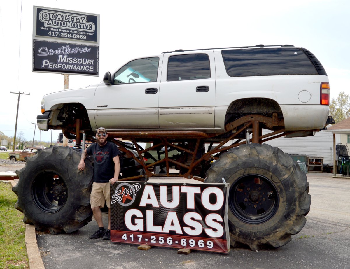 Tire, Spoke, Wheel, Person. Text: QUALITY AUTOMOTIVE &quot;Auto Glass Repair &amp; Replacement&quot; 417-256-6969 Southern SMP AUTO GLASS 417-256-6969