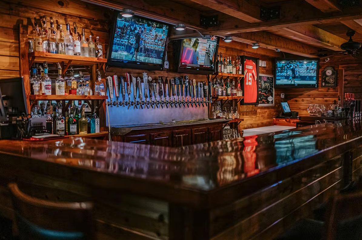 Bar, Building, Urban, Person. Text: ULTRA 15 BUSCH LIGHT