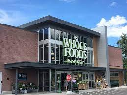 Shopping Mall, Office Building, Convention Center, City. Text: WHOLE FOODS MARKET