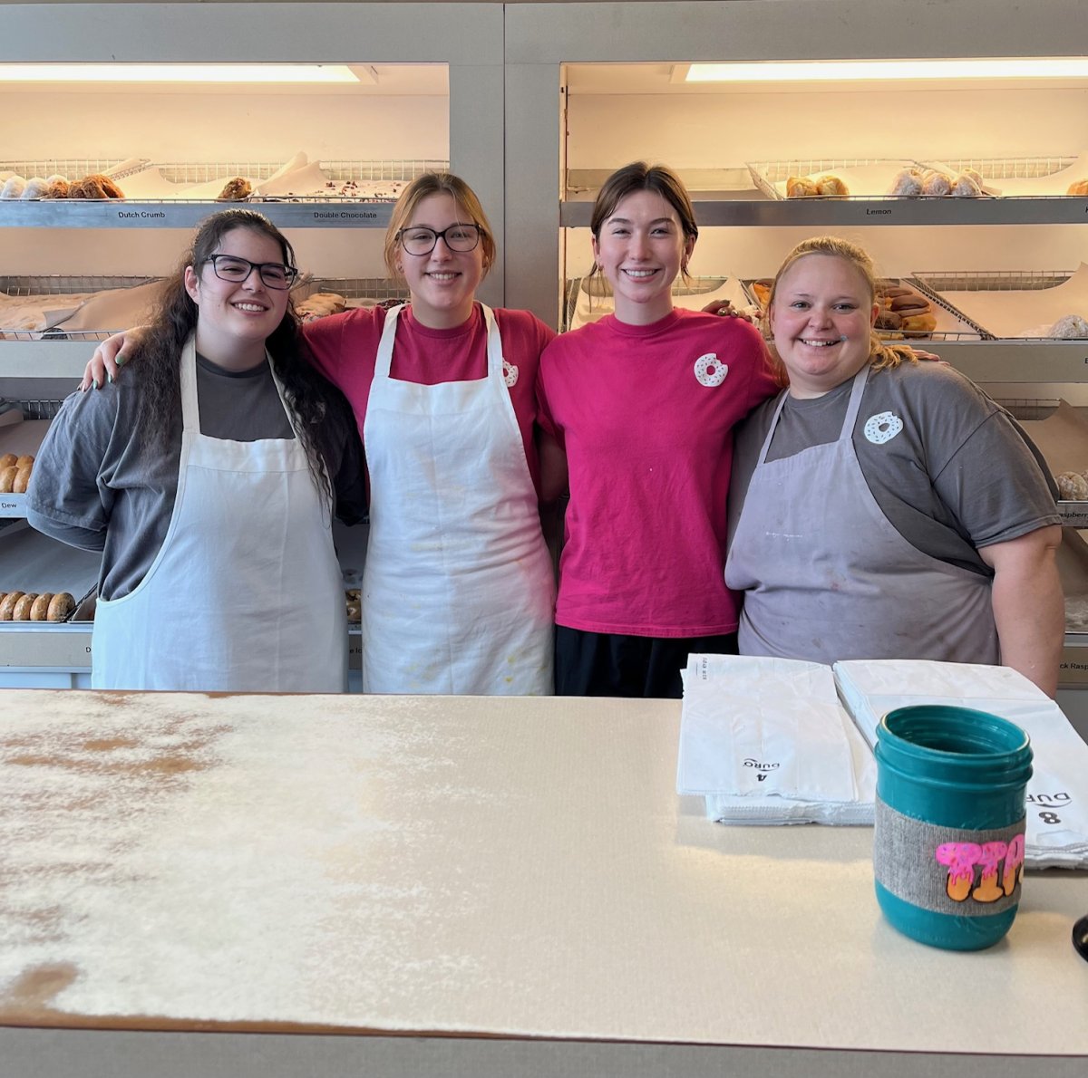 Glasses, Person, Adult, Woman. Text: Lemon Dutch Crumb Double Chocolate Dew ck Rasp 8