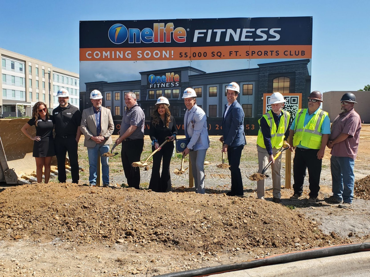 Worker, Shovel, Smoke Pipe, Soil. Text: Onelife® FITNESS COMING SOON! 55, 000 SQ. FT. SPORTS CLUB Onelife FITNESS 2 53