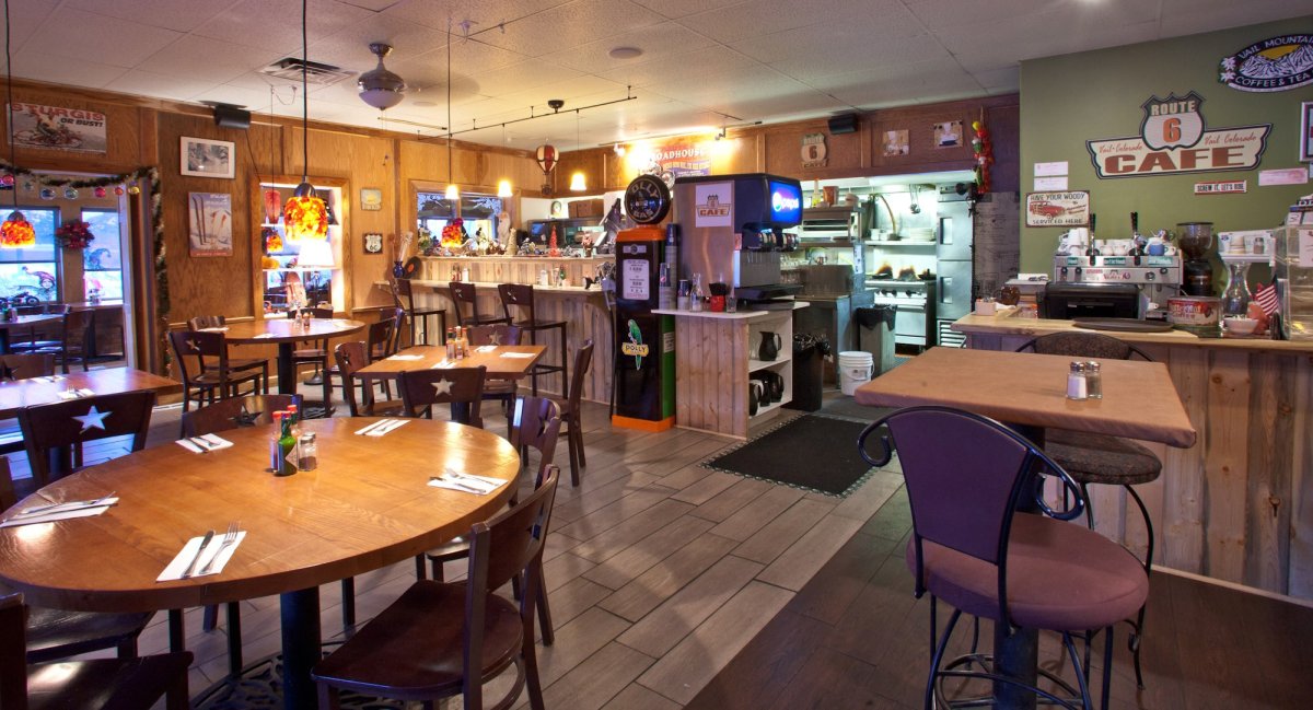 Restaurant, Cafeteria, Cafe, Dining Table. Text: COFFEE &amp; TEA STURGIS ROUTE OR BUST! 6 ROUTE Vail Colorado 6 CAFE CAFE HAVE YOUR WOODY CAFE SERVICED HERE Coffee POLLY