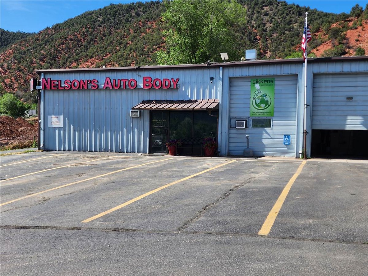 Architecture, Building, Loading Dock. Text: NELSON&#039;S AUTO BODY sikkens AUTOWAVE WARNING
